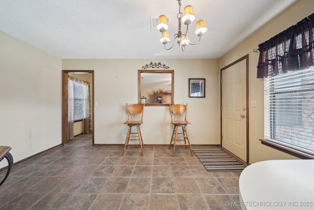 foyer entrance featuring an inviting chandelier