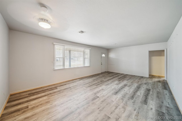 empty room with light hardwood / wood-style floors