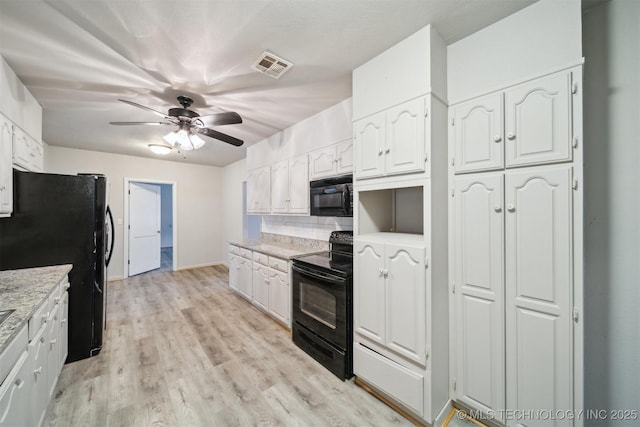 kitchen featuring backsplash, black appliances, light hardwood / wood-style floors, and white cabinets