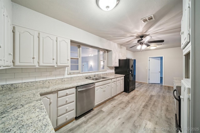 kitchen with white cabinetry, light hardwood / wood-style flooring, and black appliances