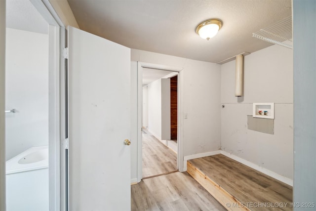 laundry area with washer hookup and light hardwood / wood-style floors