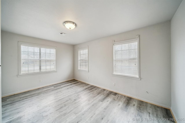 spare room with light hardwood / wood-style flooring