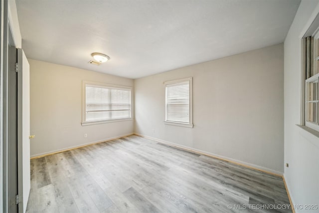 empty room with light hardwood / wood-style floors