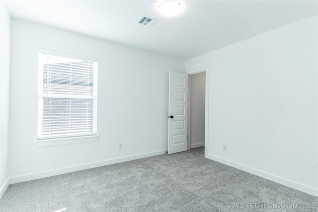 empty room featuring light carpet