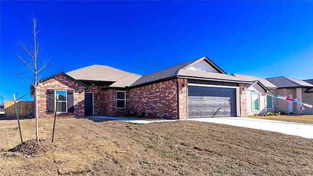 single story home featuring a garage and a front lawn