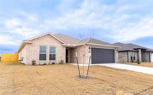 single story home featuring a garage and a front yard