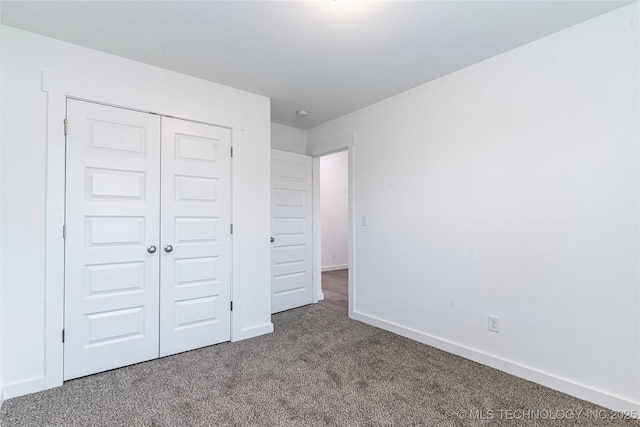 unfurnished bedroom featuring a closet and carpet flooring