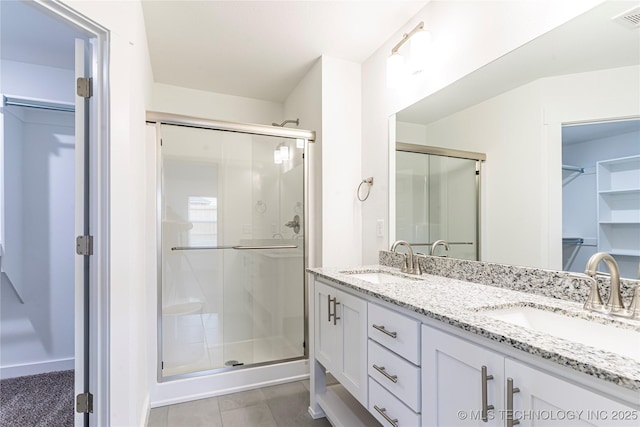 bathroom featuring walk in shower and vanity