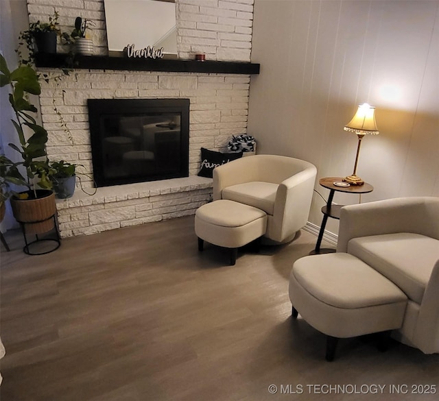 sitting room with wood-type flooring