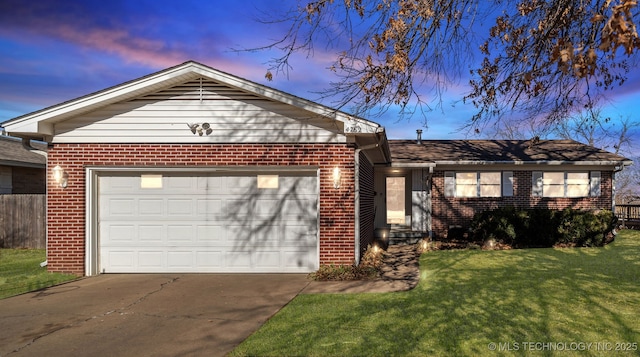 ranch-style house with a garage and a lawn