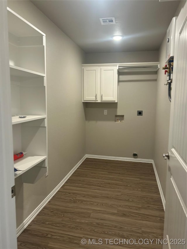 laundry area with cabinets, electric dryer hookup, dark hardwood / wood-style floors, and washer hookup