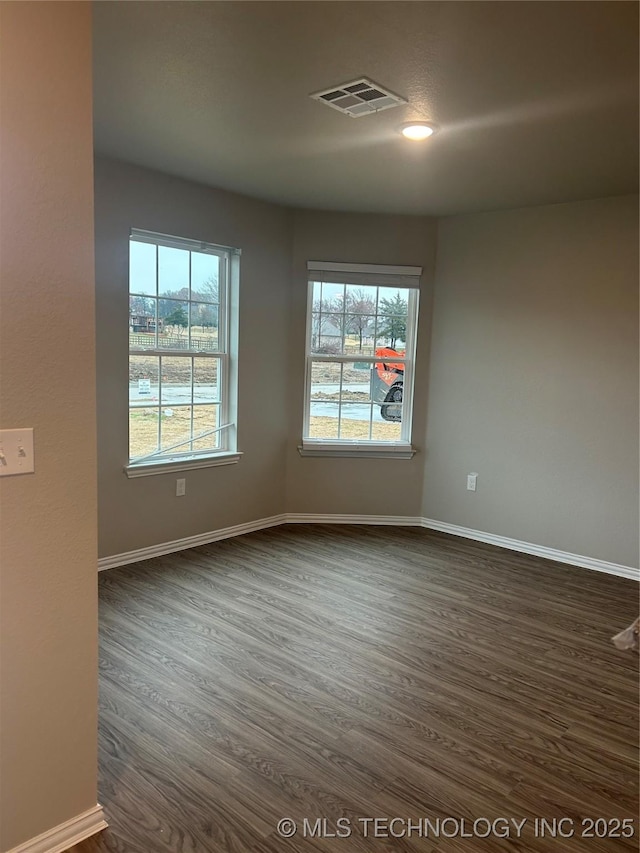 unfurnished room featuring dark wood-type flooring