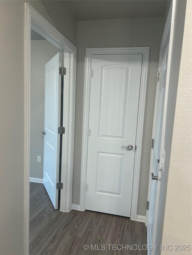 corridor featuring dark hardwood / wood-style flooring