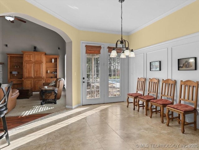 tiled dining area with crown molding and ceiling fan