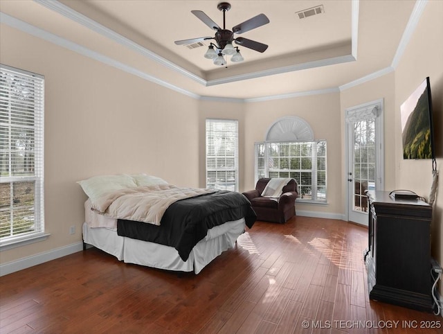 bedroom featuring crown molding, access to outside, dark hardwood / wood-style flooring, and a tray ceiling