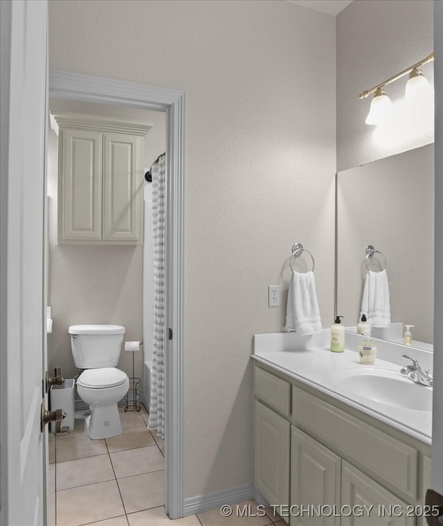 bathroom with vanity, tile patterned flooring, curtained shower, and toilet