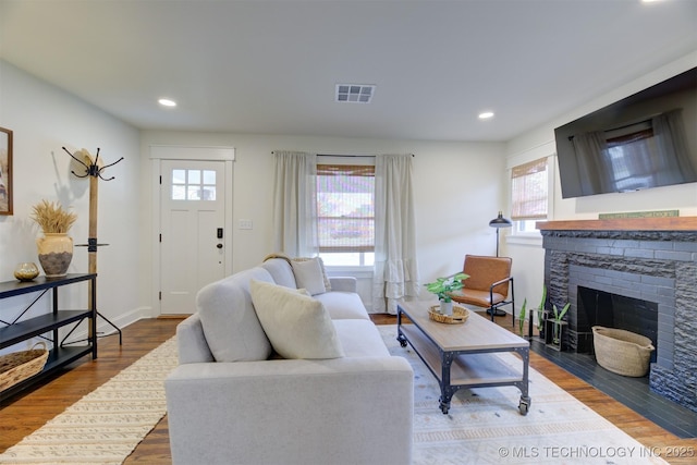 living room with hardwood / wood-style floors and a fireplace