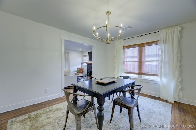 dining room with an inviting chandelier and dark hardwood / wood-style floors