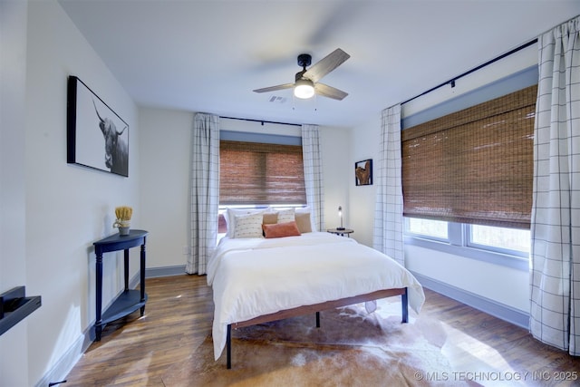 bedroom featuring hardwood / wood-style floors and ceiling fan