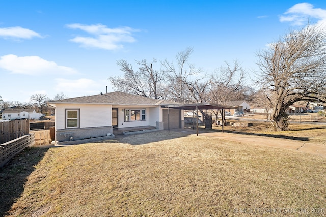 ranch-style home featuring a front yard and a carport