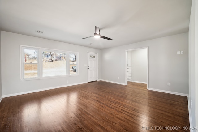 unfurnished living room with dark hardwood / wood-style floors and ceiling fan