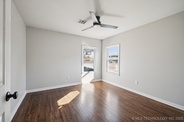 empty room with dark hardwood / wood-style flooring and ceiling fan