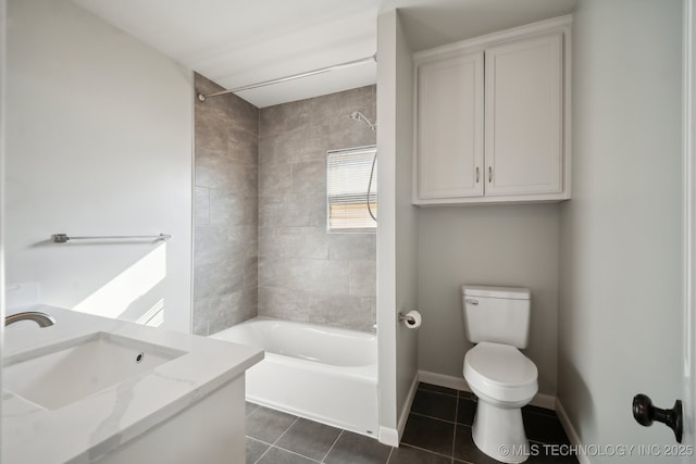 full bathroom featuring tile patterned flooring, vanity, tiled shower / bath combo, and toilet