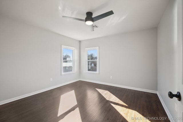 spare room featuring dark wood-type flooring and ceiling fan