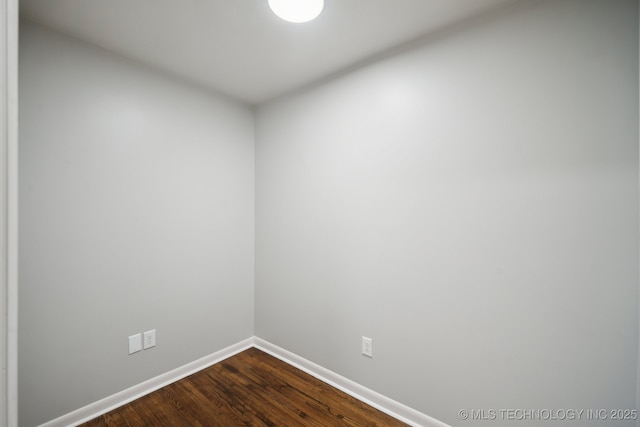 spare room with wood-type flooring