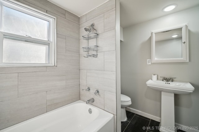 full bathroom featuring tiled shower / bath, toilet, tile patterned flooring, and sink