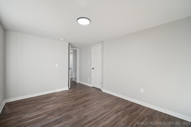 spare room featuring dark wood-type flooring