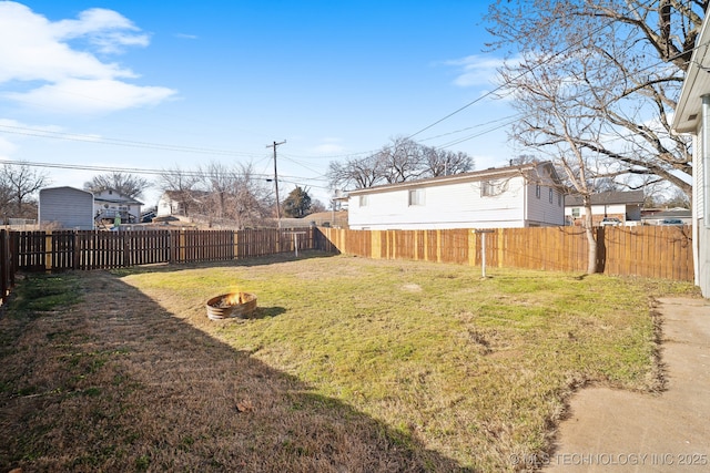 view of yard with a fire pit