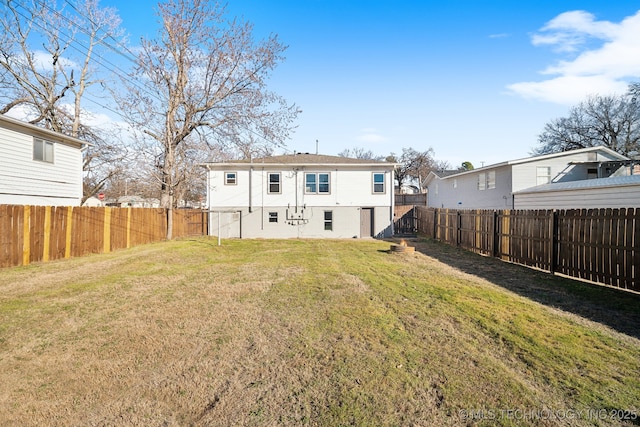 back of house with a lawn