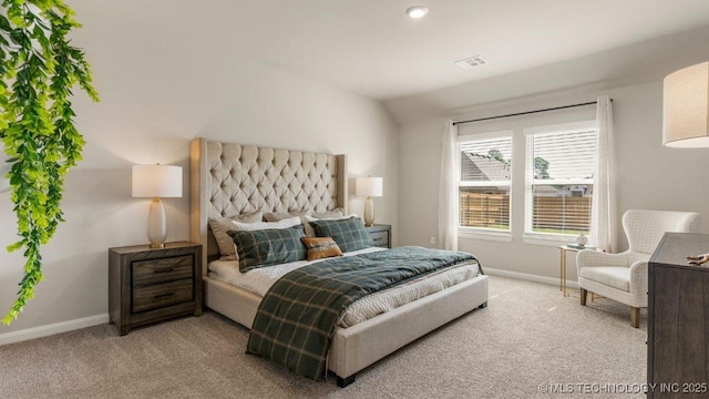 carpeted bedroom featuring lofted ceiling