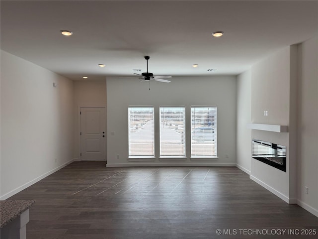 unfurnished room featuring ceiling fan and dark hardwood / wood-style flooring