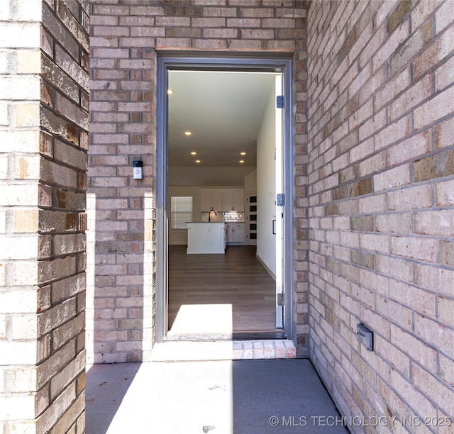 view of exterior entry with brick siding