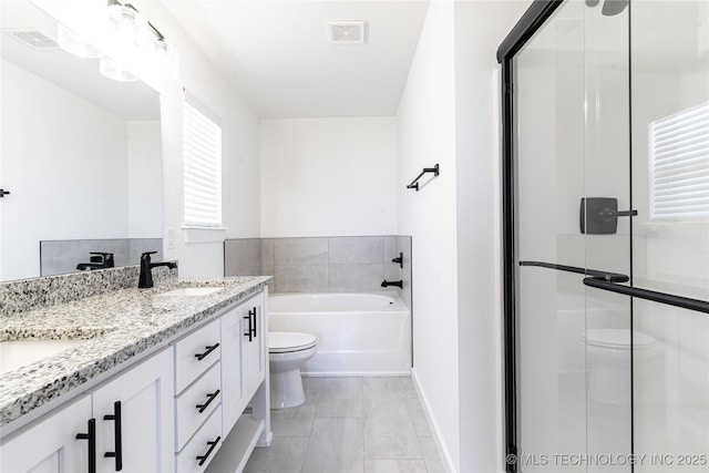 bathroom featuring double vanity, visible vents, toilet, a sink, and a bath