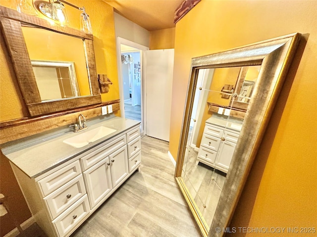 bathroom featuring vanity and hardwood / wood-style floors