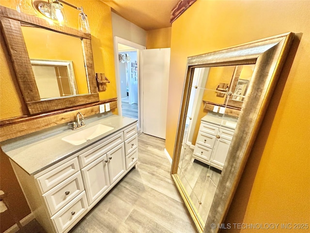 610 SW 7th Rd, Stigler, OK 74462 - bathroom featuring wood finished floors and vanity