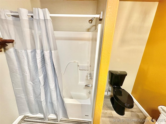 bathroom with shower / bathtub combination with curtain and toilet