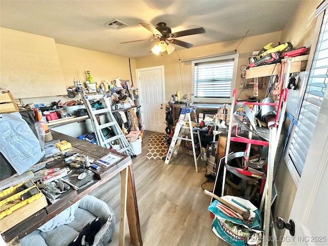 misc room with wood-type flooring and ceiling fan