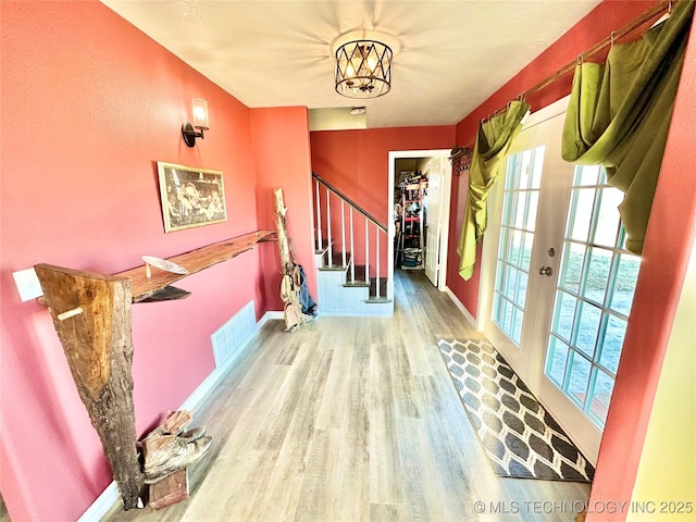 interior space with hardwood / wood-style floors and french doors