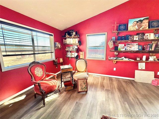 sitting room featuring lofted ceiling and hardwood / wood-style floors