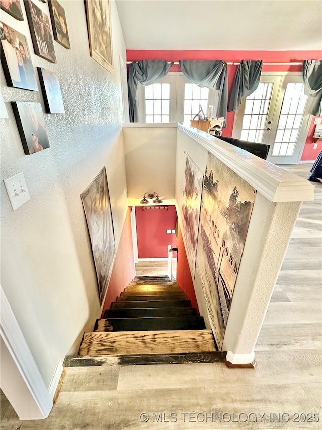 stairs featuring hardwood / wood-style floors