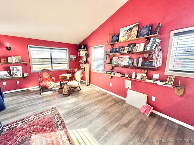 living area featuring hardwood / wood-style flooring and vaulted ceiling