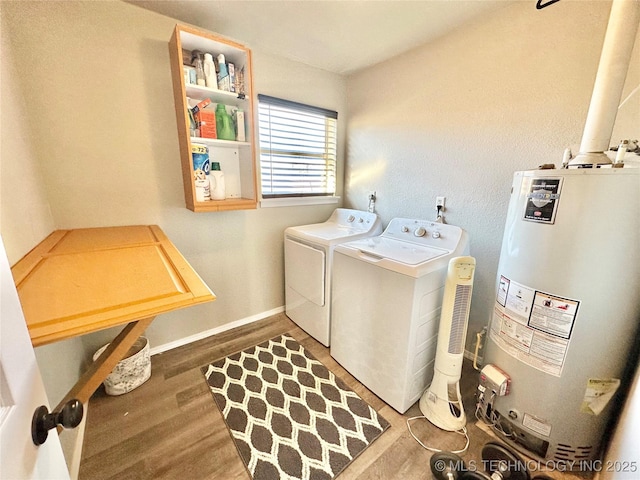 610 SW 7th Rd, Stigler, OK 74462 - washroom featuring water heater, baseboards, washer and clothes dryer, laundry area, and wood finished floors