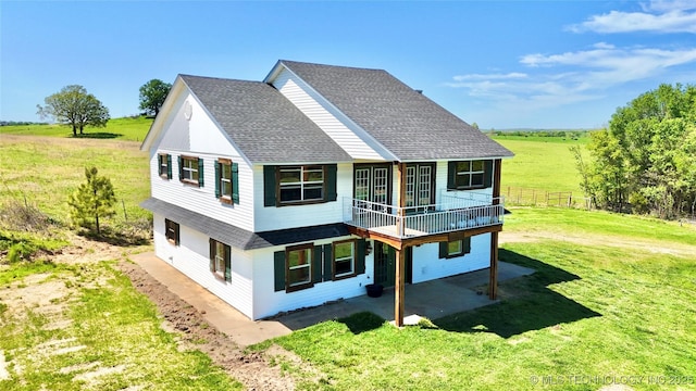 610 SW 7th Rd, Stigler, OK 74462 - rear view of house featuring a yard, a rural view, a patio, and roof with shingles