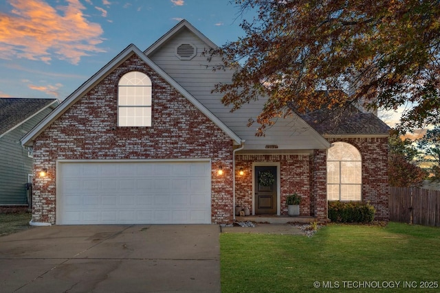 front of property featuring a garage and a lawn