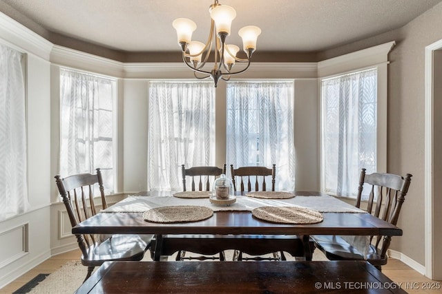 dining area with a chandelier and light hardwood / wood-style flooring