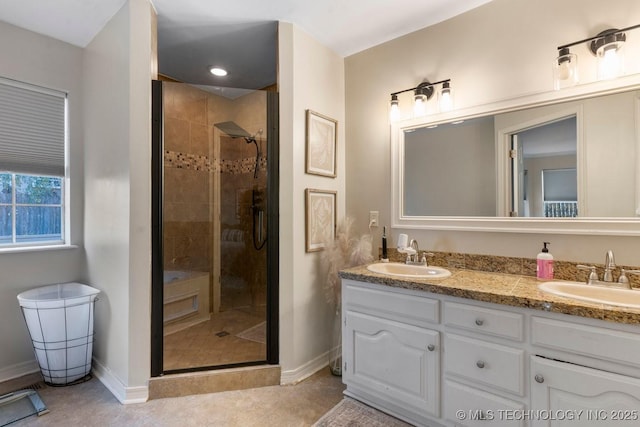 bathroom with a shower with door, vanity, and tile patterned flooring